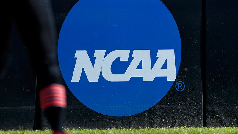 FILE - An athlete stands near the NCAA logo during a softball game in Beaumont, Texas, April...