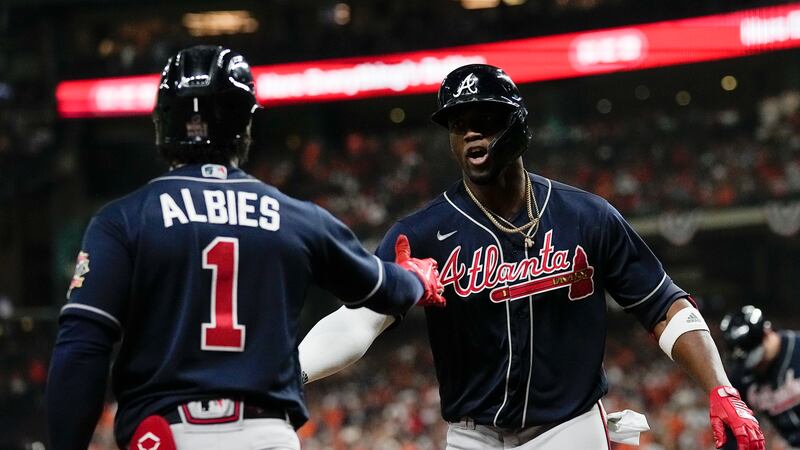 Atlanta Braves' Jorge Soler celebrates with Ozzie Albies after a home run during the first...