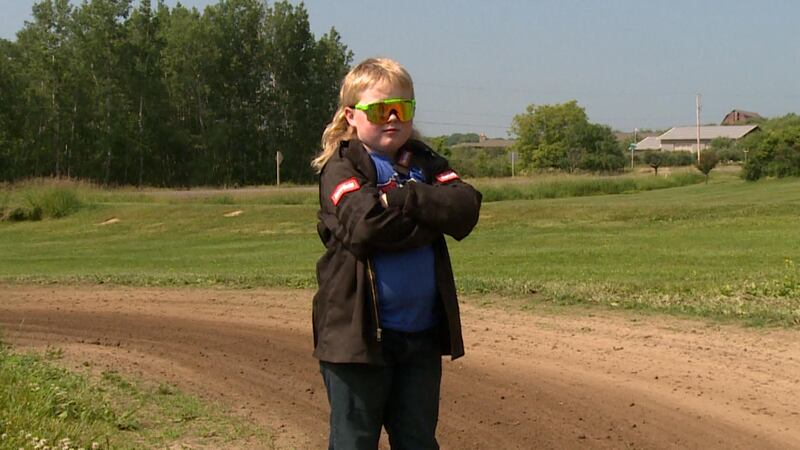 Emmitt Bailey stands at a go-kart track in Chippewa Valley where he practices for races.